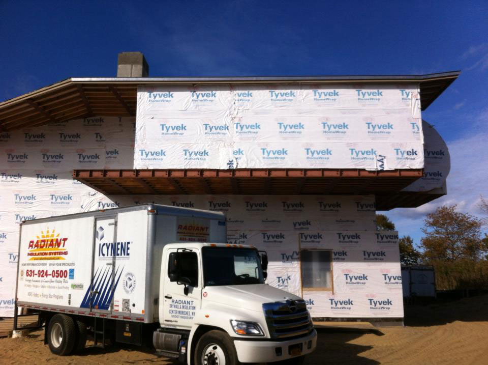 Radiant insulation truck outside of home construction