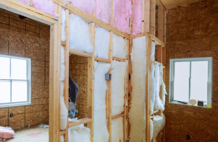 building-under-construction-and-renovation-inside batt fiberglass insulation being installed during home construction