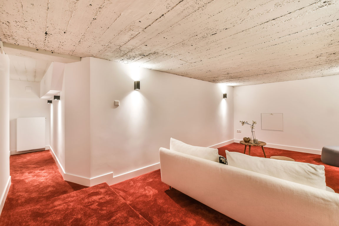 finished basement with red carpet and insulation